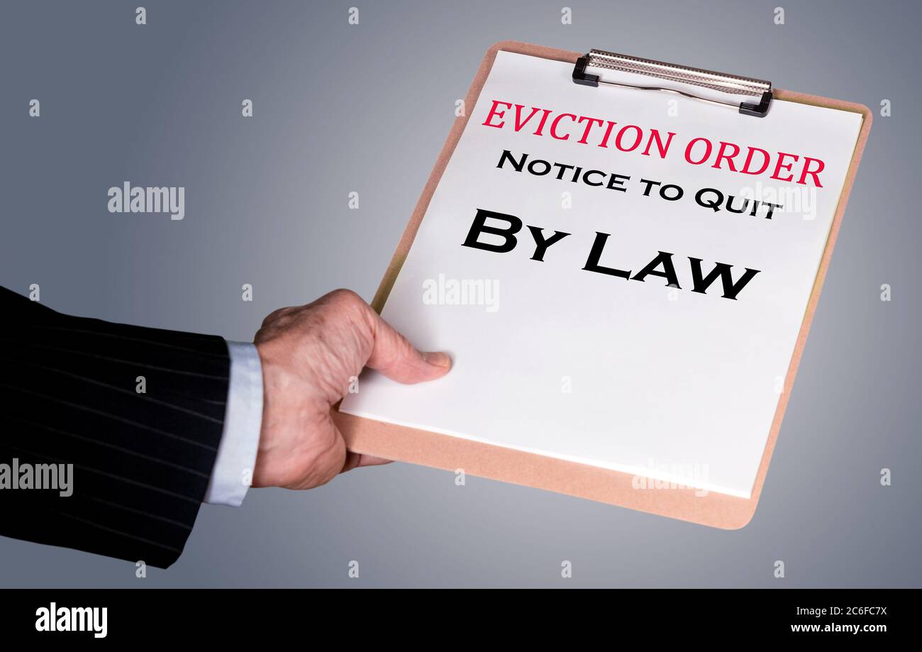 Man in suit serving an eviction notice to a defaulting renter in due to