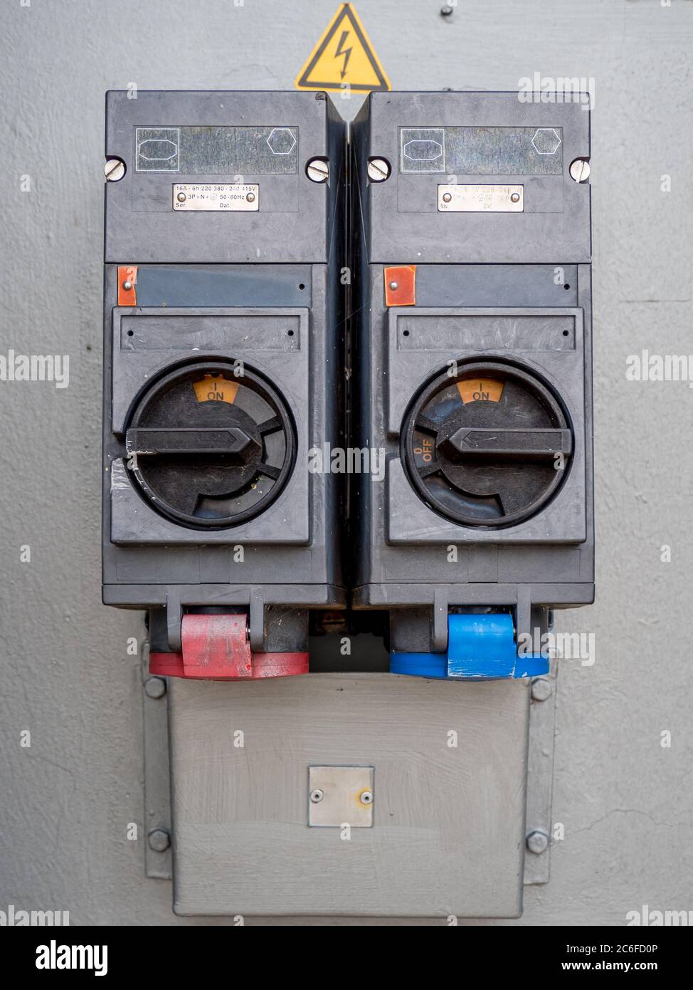 two old industrial high voltage switches on gray background Stock Photo