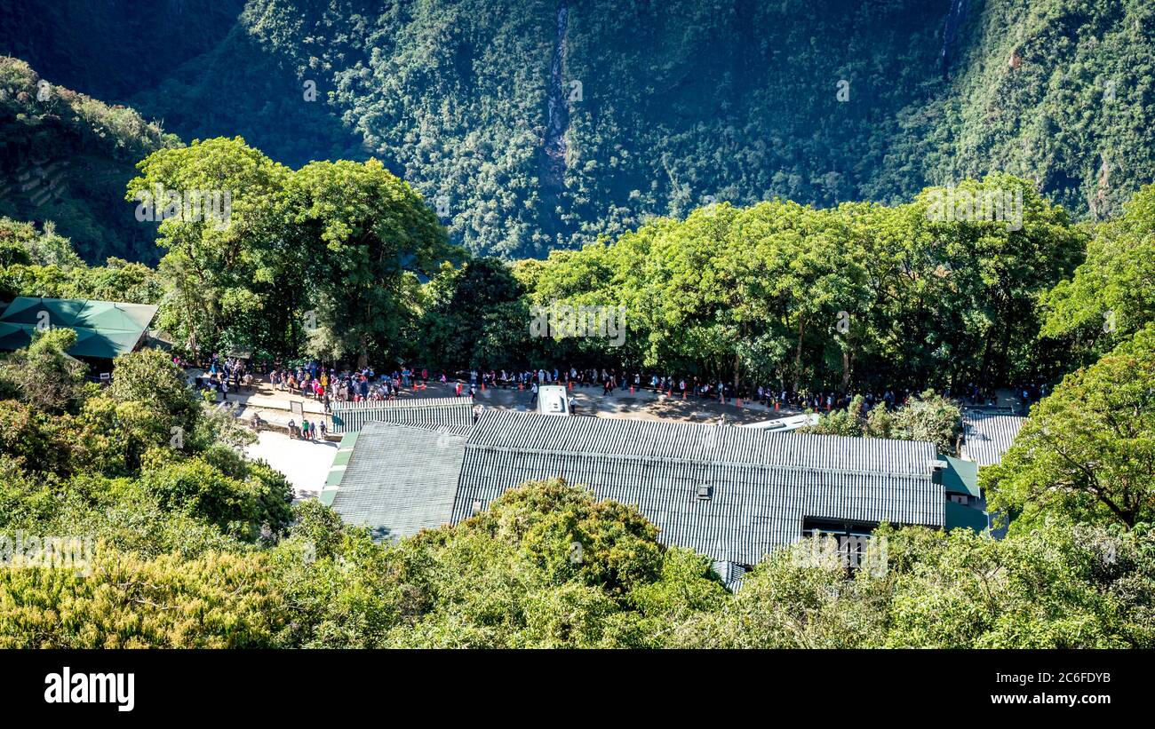Long queue of people in front of machu picchu Stock Photo