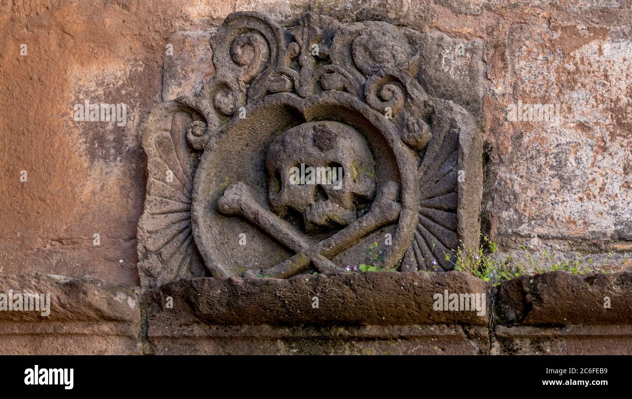 Ornament with a skull and crossbones above the chamber of ancient religious inquisition at cusco cathedral in peru. Stock Photo