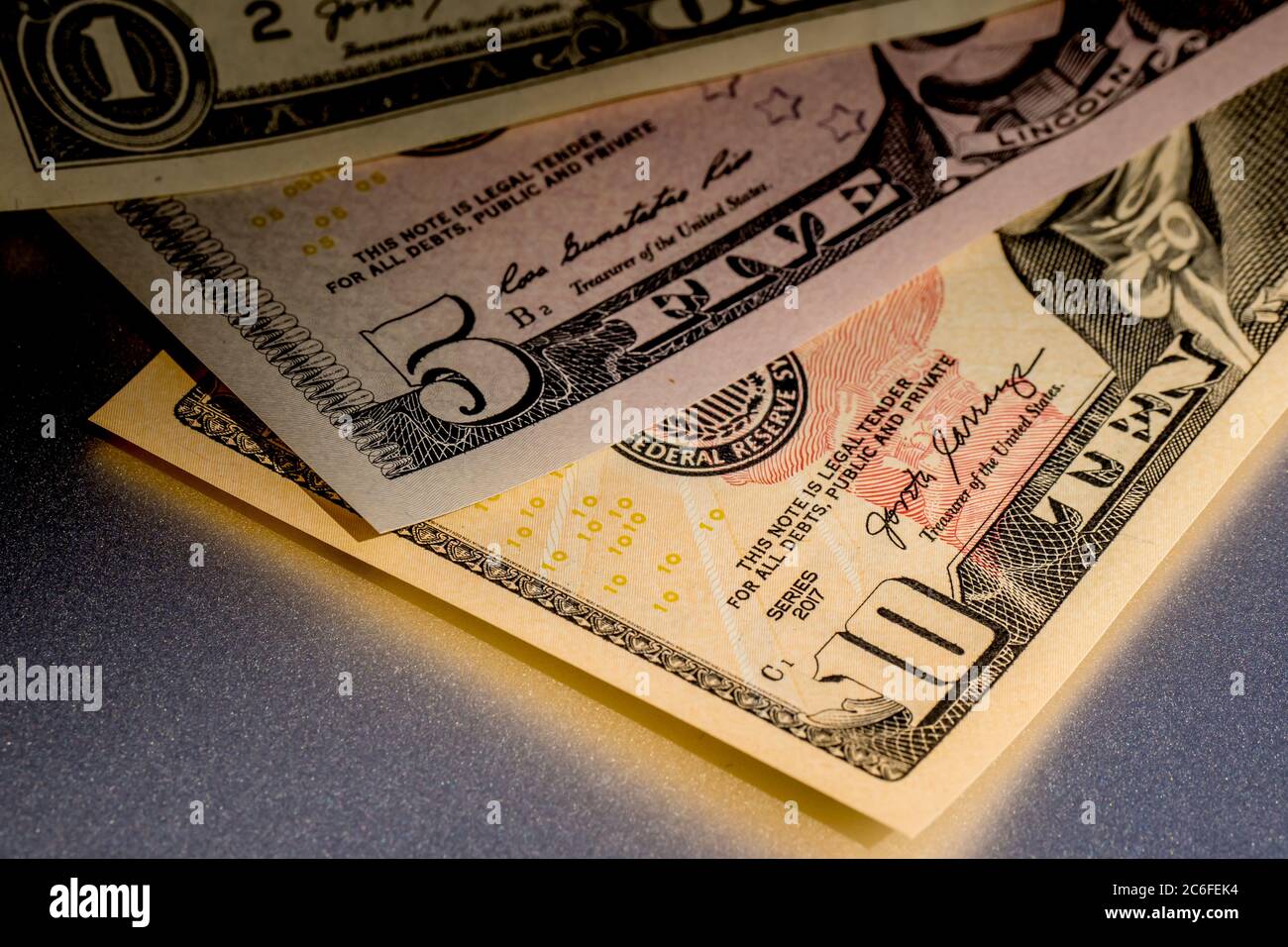 close up of a variation of different denominations of fiat money, legal tender of the united states of america, ten dollar bill with five us-dollar Stock Photo