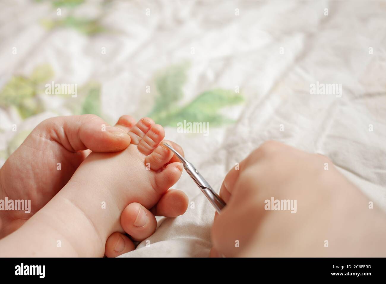 A man cuts her nails child hygiene. men s hands hold nail scissors