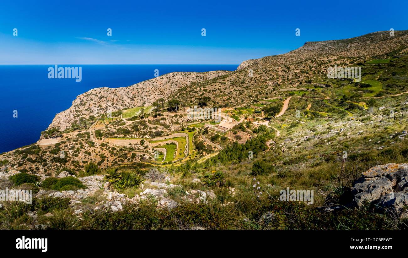 view over the old terraces and ruins of la trapa monastery nearby sant elm in springtime on mallorca, hiking route gr221 ruta de piedra en seco Stock Photo