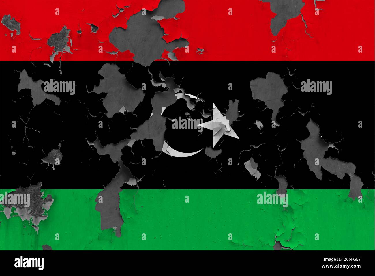 Libya flag close up painted, damaged and dirty on wall peeling off ...