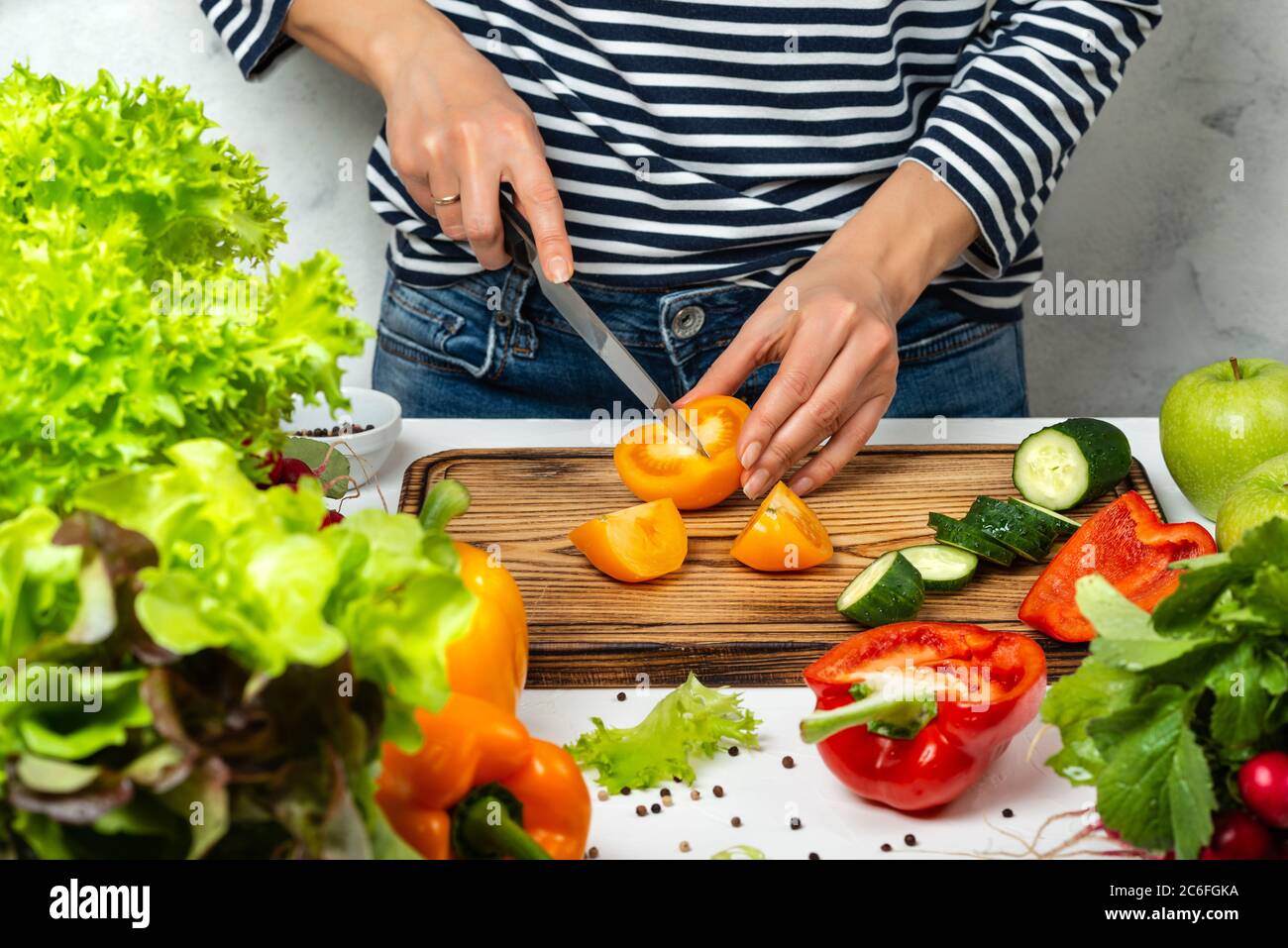 Cooking healthy vegan diet food concept. Cutting vegetables in the