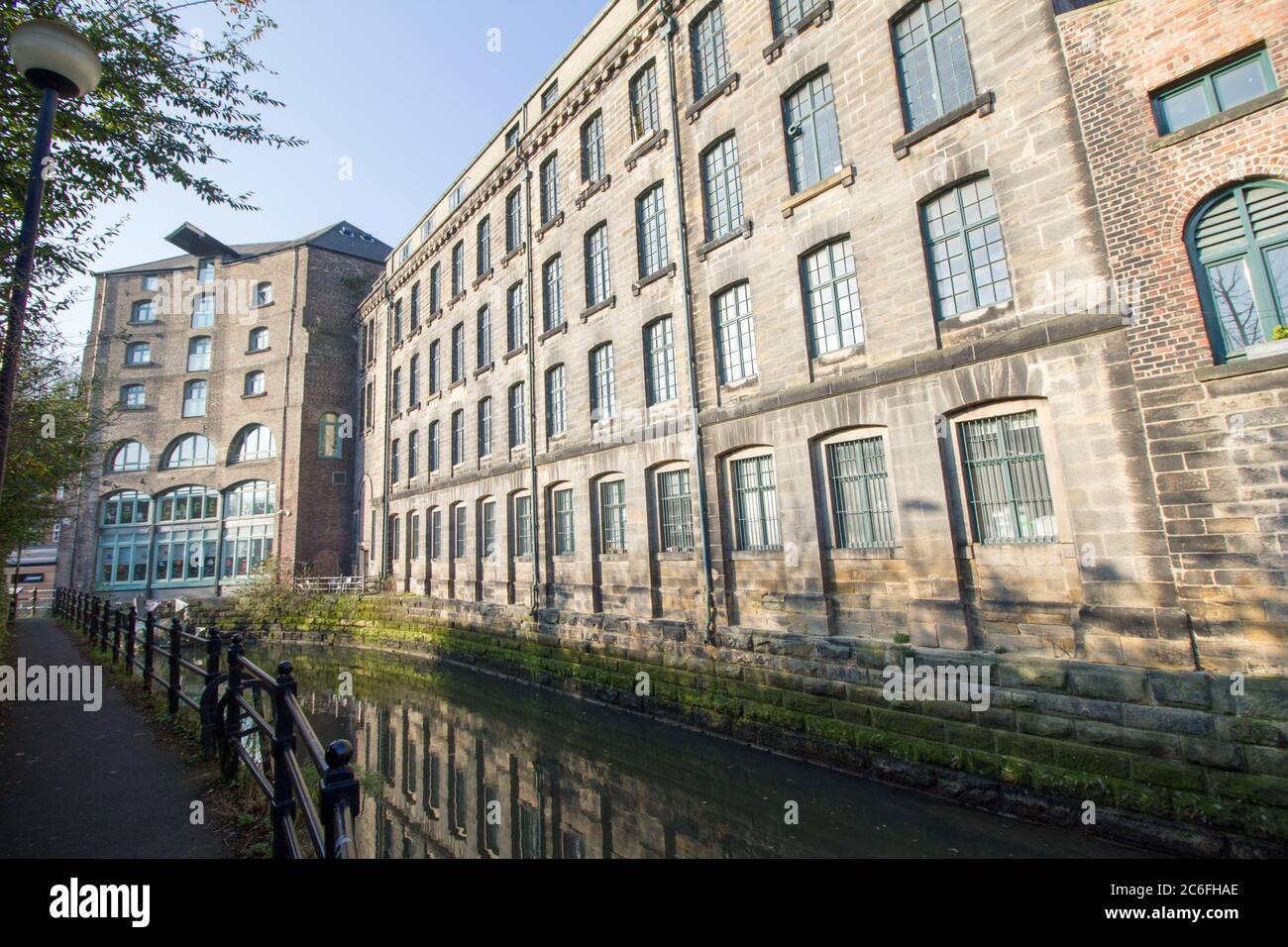 Old warehouses, reflected in to the river, converted into mixed use developments in Ouseburn, Newcastle-Upon-Tyne Stock Photo