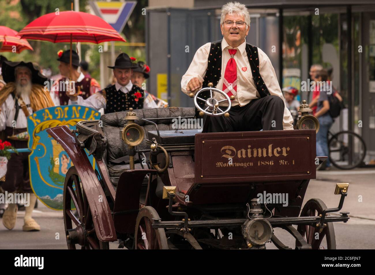 Villach, Austria - August 3th, 2019: An older man riding a oldtimer at the Villacher Kirchtag, the largest traditional festival in Austria Stock Photo