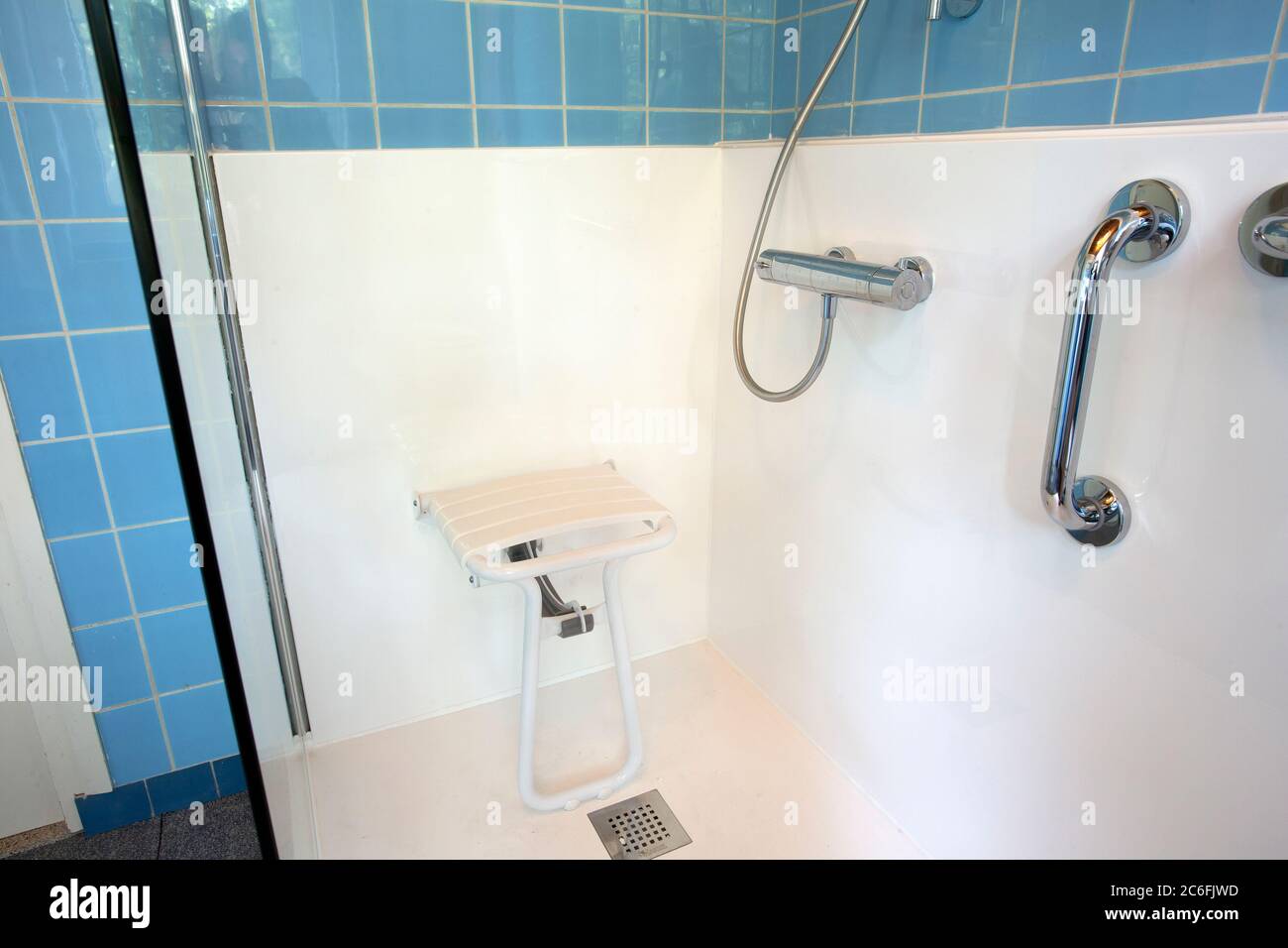 Handicapped disabled shower chair for elderly or disabled people with handle bar in senior home, safety concept Stock Photo