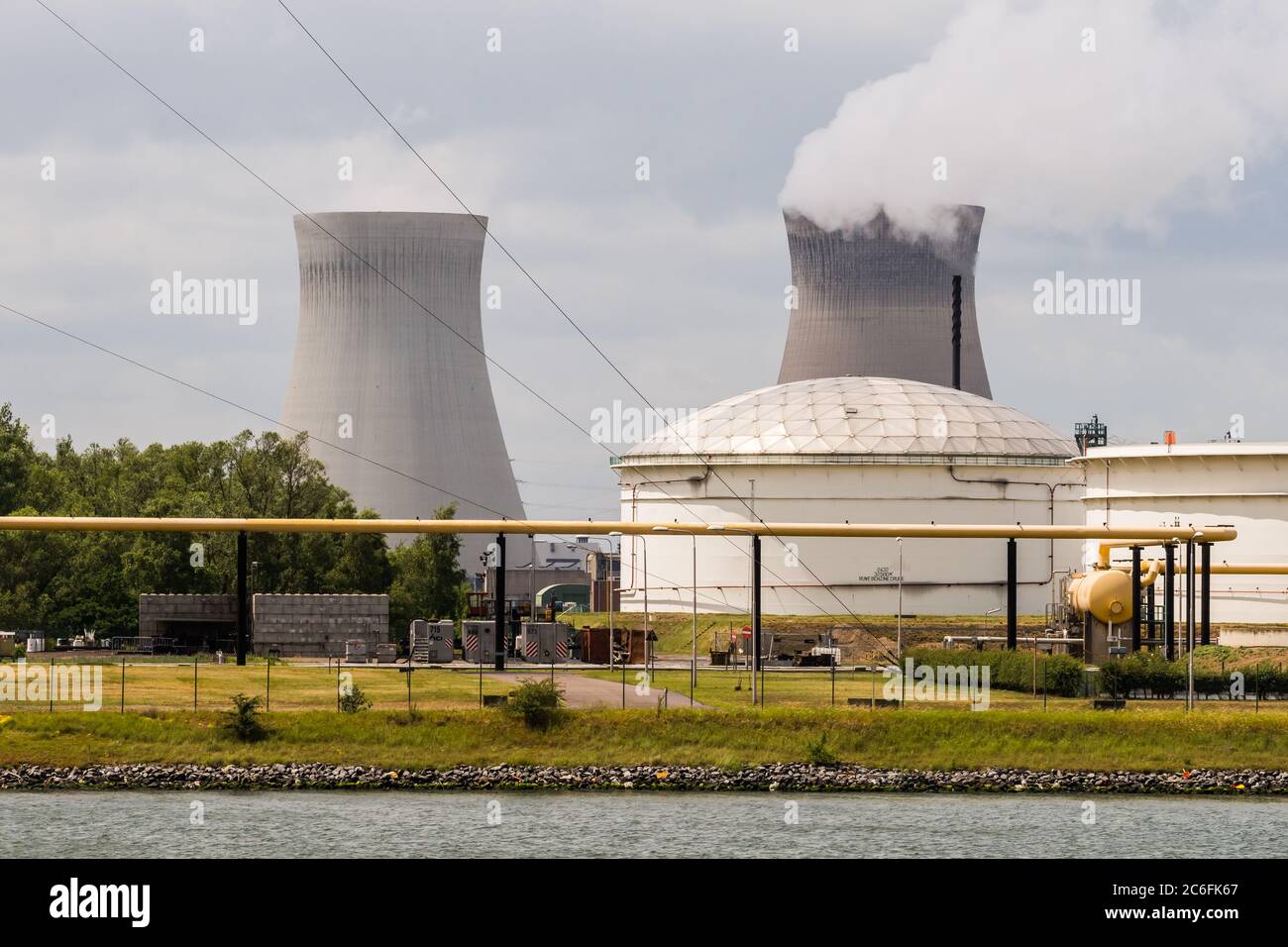 Antwerp, Belgium - June 8th, 2019: View over some petrochemical industry installations in the port of Antwerp to the Nuclear Power Plant Doel Stock Photo