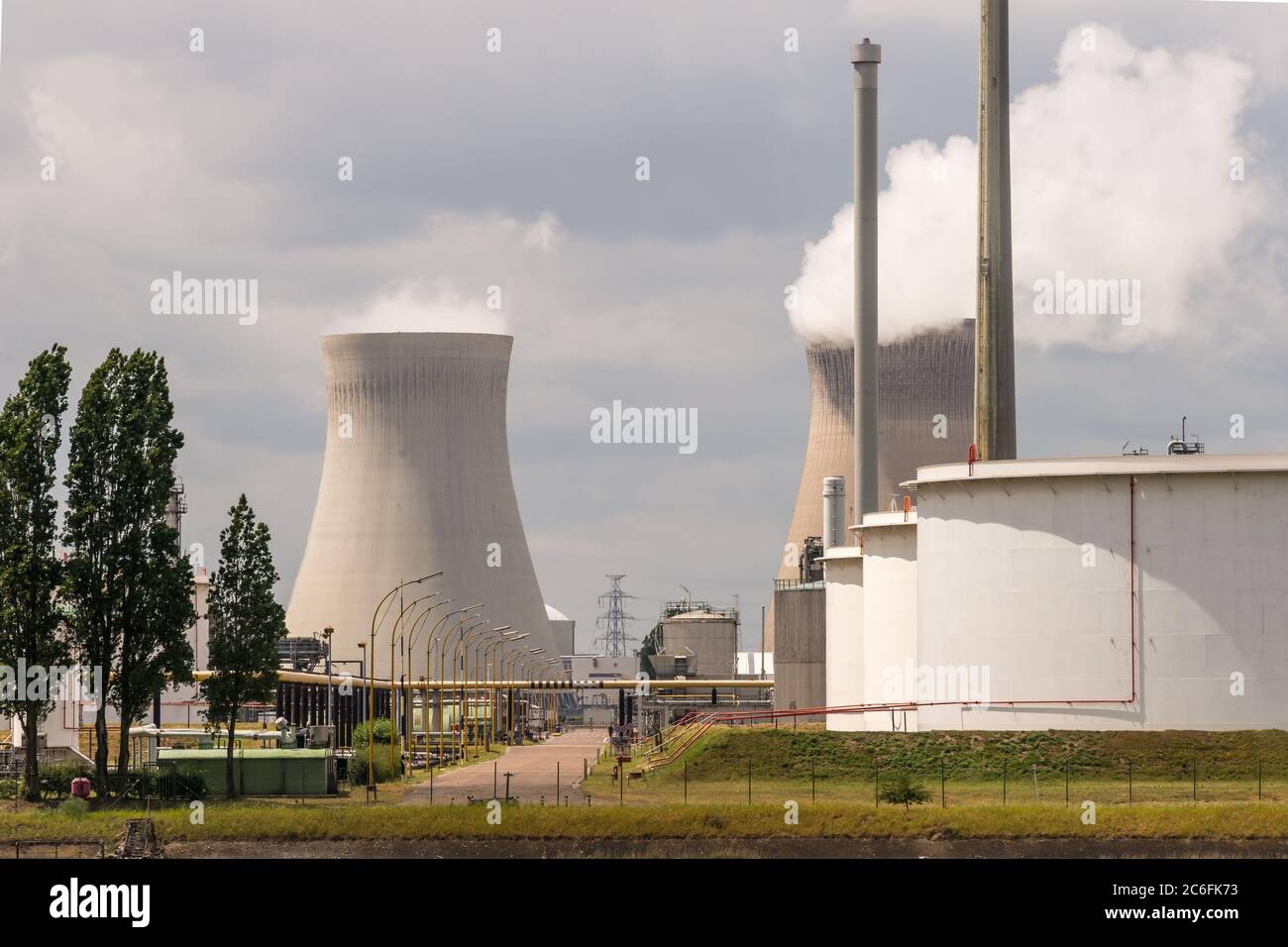 Antwerp, Belgium - June 8th, 2019: View over some petrochemical industry installations in the port of Antwerp to the Nuclear Power Plant Doel Stock Photo