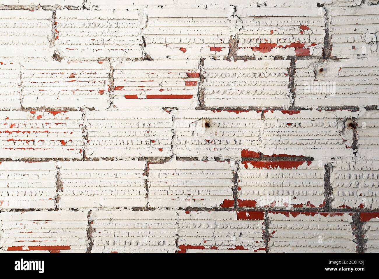 an old white painted red brick wall background Stock Photo