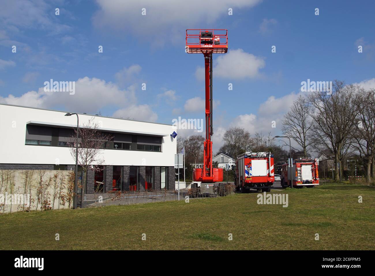Modern fire station in the Dutch village of Bergen with fire engines and a telescopic boom lift. Netherlands, March Stock Photo