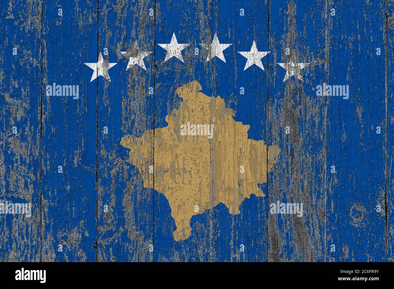 Kosovo flag on grunge scratched wooden surface. National vintage background. Old wooden table scratched flag surface. Stock Photo