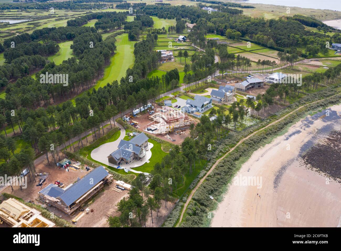 Aerial view of modern large luxury houses on coast at exclusive
