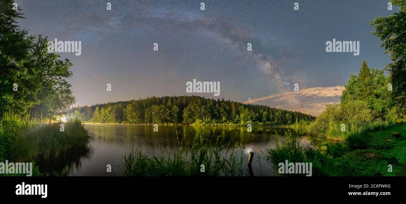 The impressive millkyway galaxy captured with its panoramic arc. The big  wood lake at night with sky with stars Stock Photo - Alamy