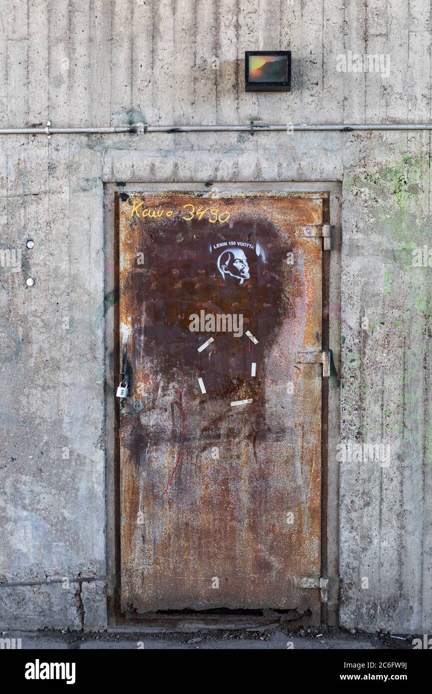 Rusty old door with Lenin stencil graffiti under Hakaniemi Bridge in Helsinki, Finland Stock Photo