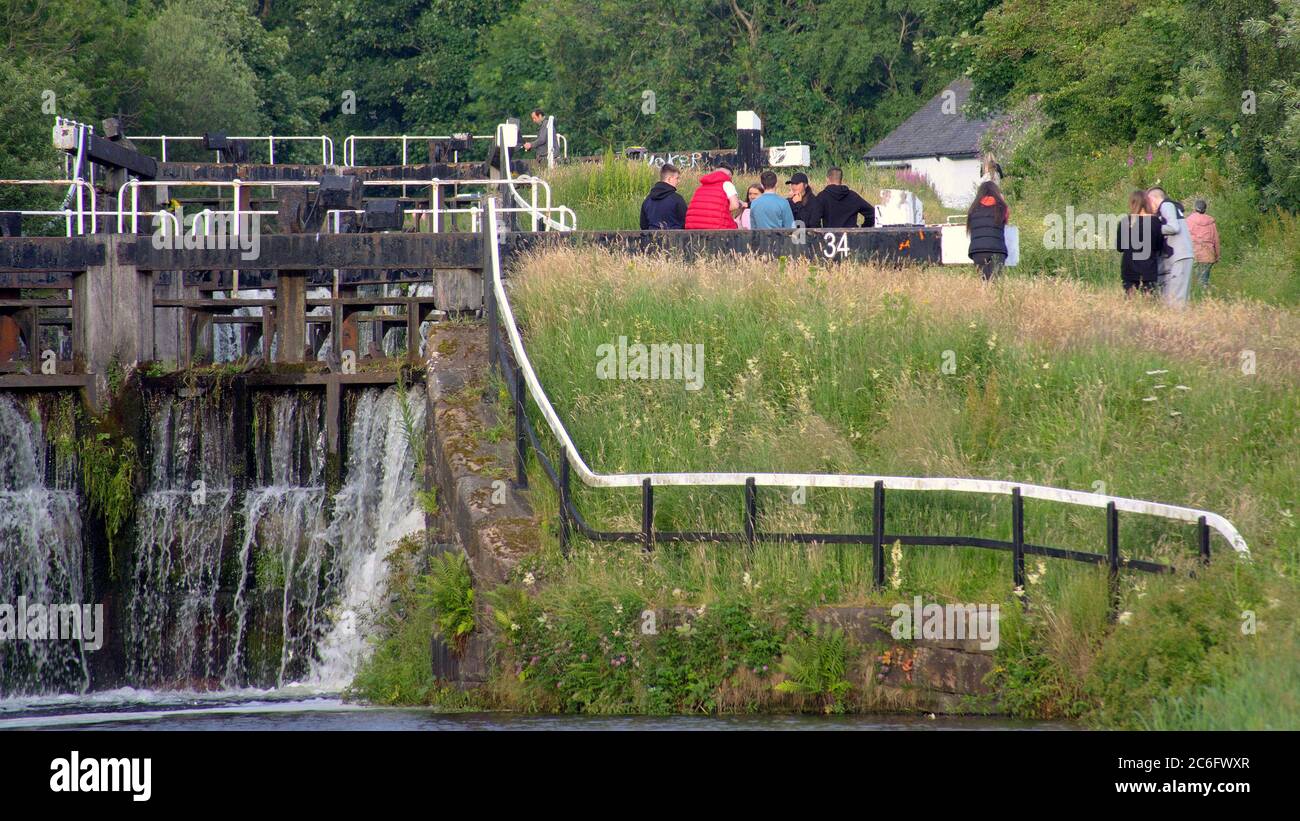 Glasgow, Scotland, UK 9th July, 2020: UK Weather:  Sunny on the forth and clyde canal saw people continue to use it to exercise and socialise during the lockdown. Credit: Gerard Ferry/Alamy Live News Stock Photo