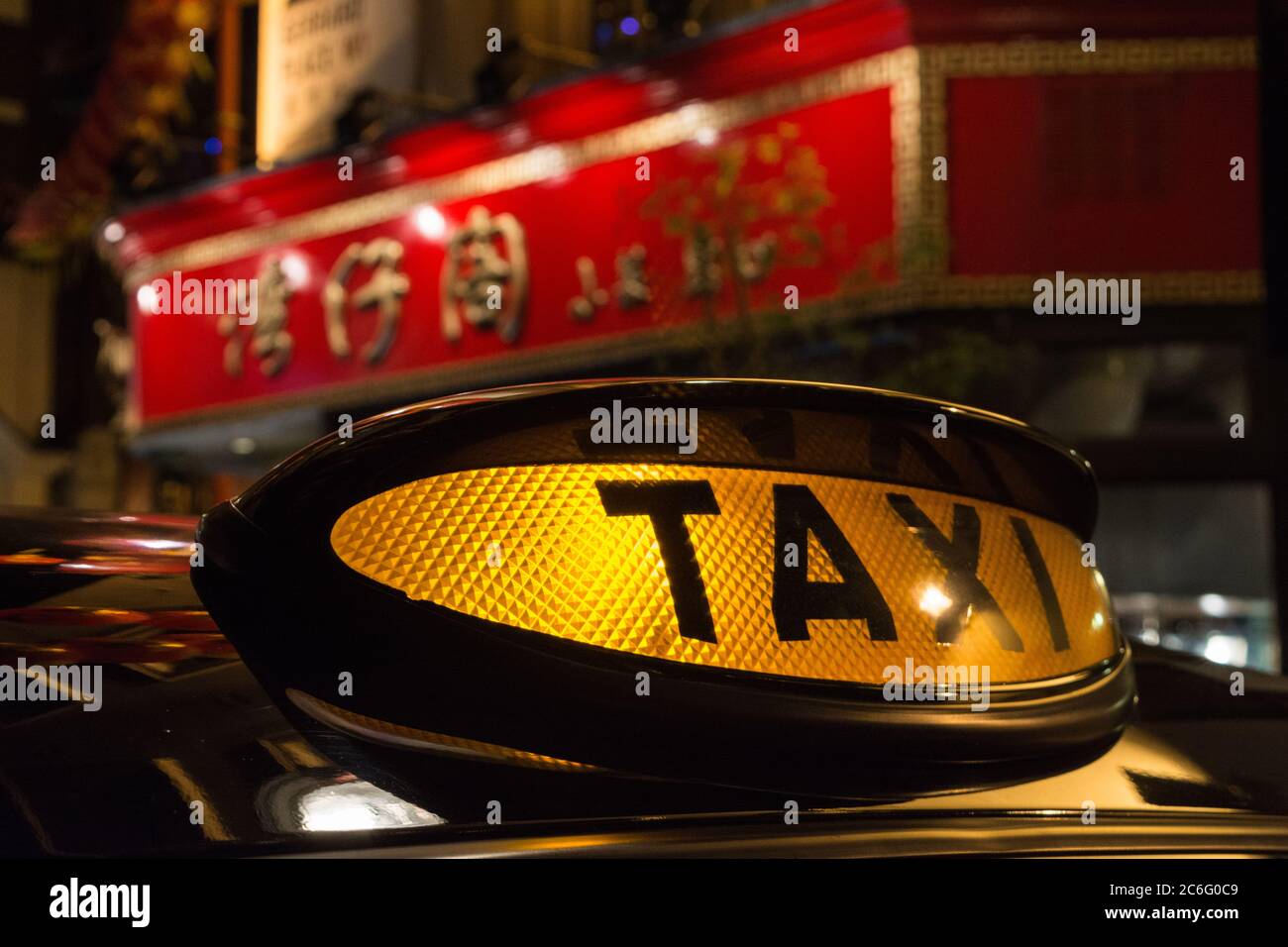 The iconic black taxi cab for-hire sign in Chinatown, Soho, Central London, UK Stock Photo