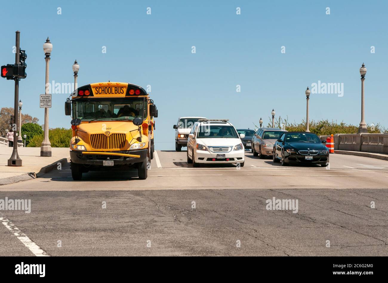 Chicago, Illinois, USA - April 23, 2012: Yellow school bus and cars stopped at the red light on the road in Chicago Downtown, Illinois, USA Stock Photo