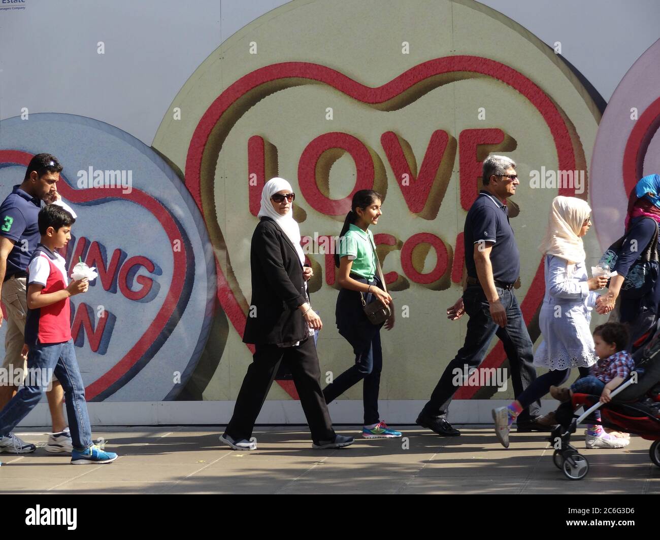 Tourists walking past Love Hearts on the King's Road, Chelsea, London UK Stock Photo