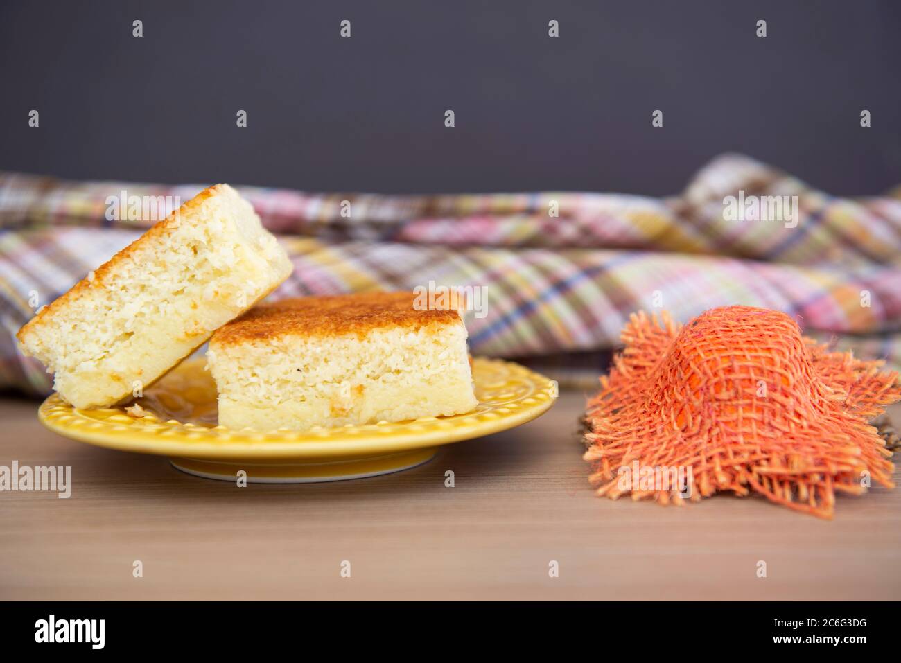 Typical June Party foods on a wooden table: Popcorn, cornmeal cake and a small country hat. Copy space. Selective focus. Stock Photo