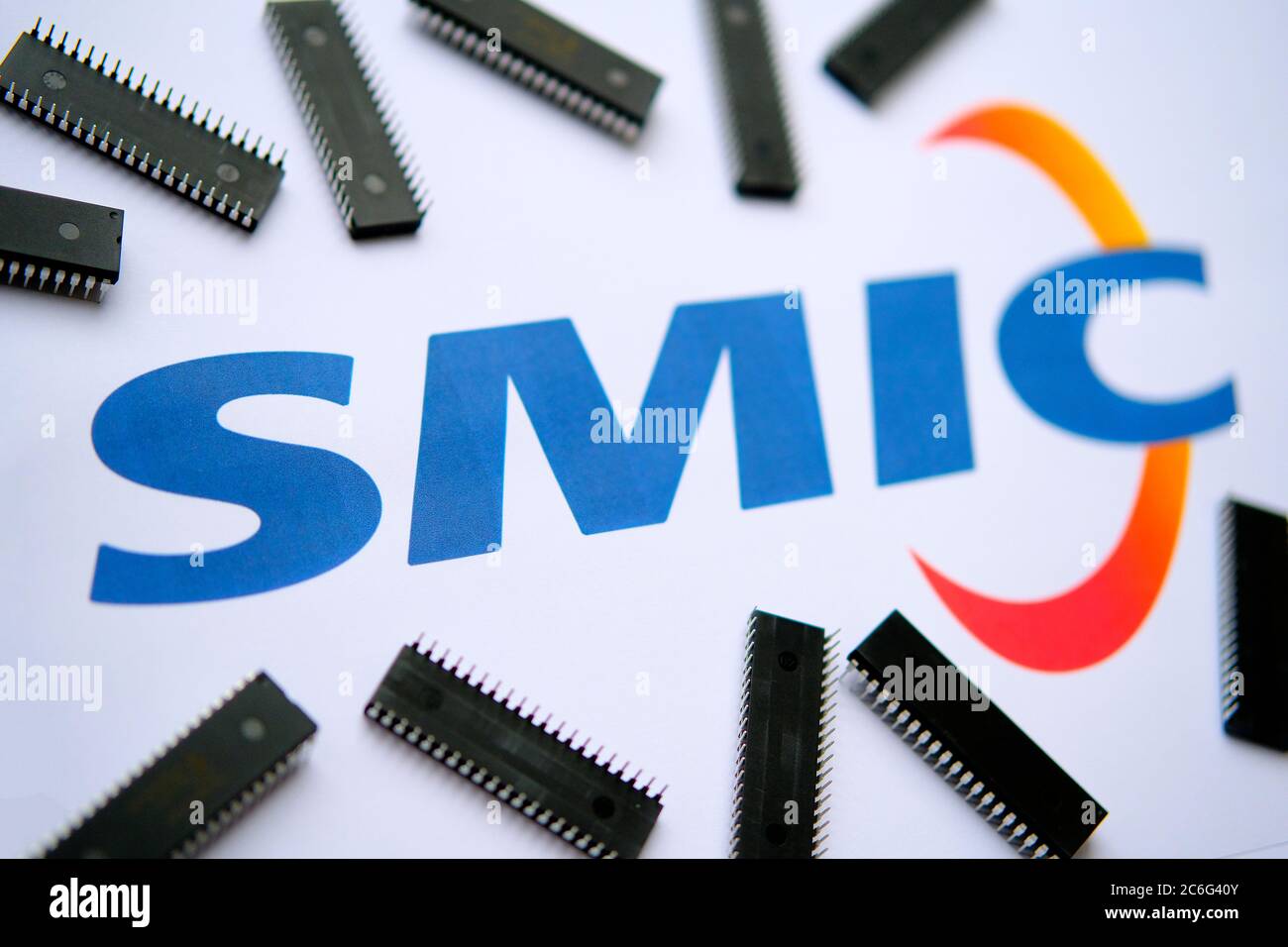 Stone / United Kingdom - July 8 2020: SMIC (Semiconductor Manufacturing International Corporation) logo on the printed document and large microchips p Stock Photo