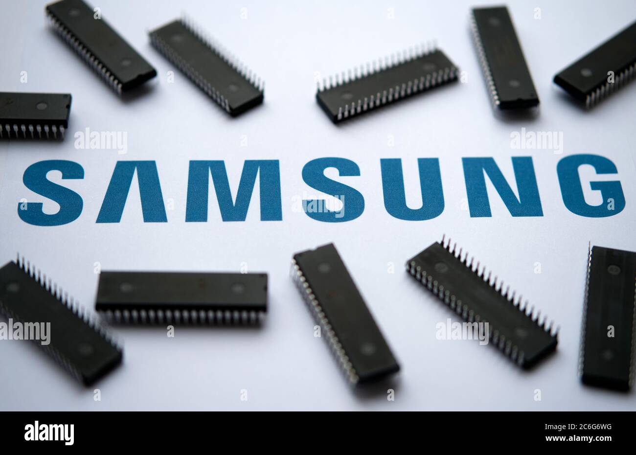 Stone / United Kingdom - July 9 2020: Samsung logo on the printed document and large microchips placed around. Selective focus. Stock Photo