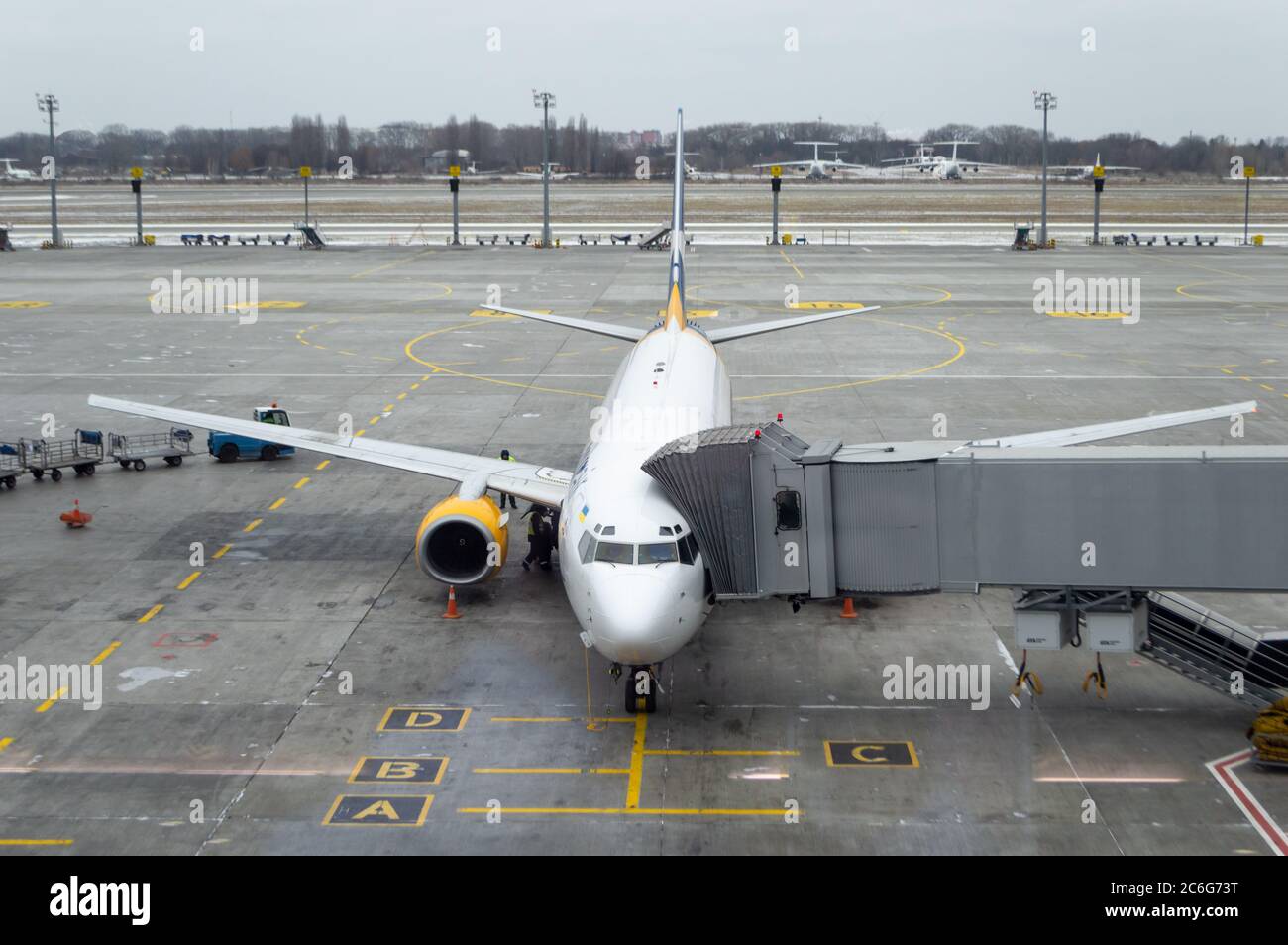 plane with jet bridge connected, ready to receive passengers at the airport. air plane at parking place. runway view. Stock Photo