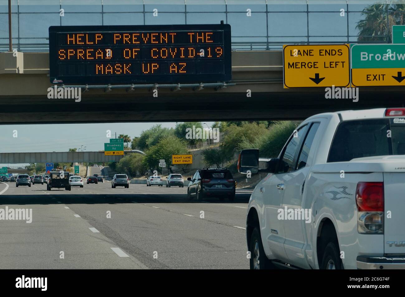 Street signs on the highway show awareness and warnings for the pandemic COVID-19. Stock Photo