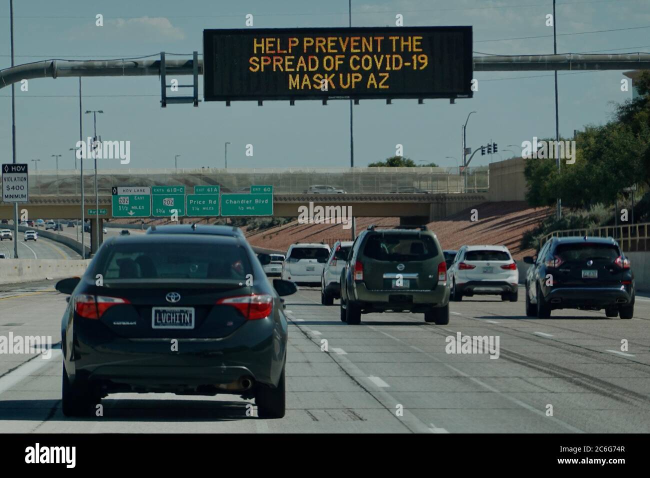 Street signs on the highway show awareness and warnings for the pandemic COVID-19. Stock Photo