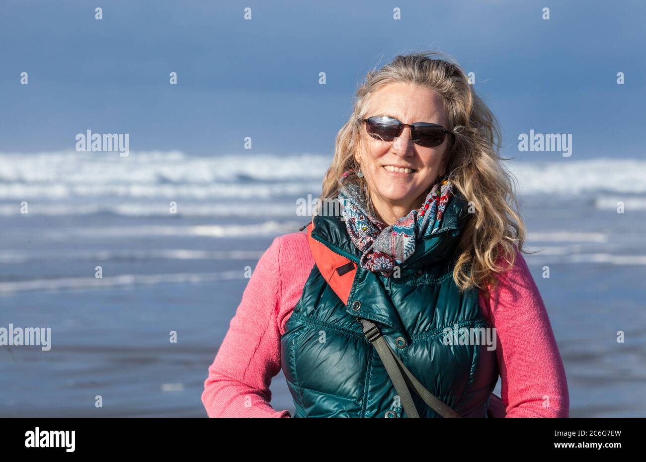 A woman standing on a beach. Pacific coast, Seaside, Oregon, USA. Stock Photo