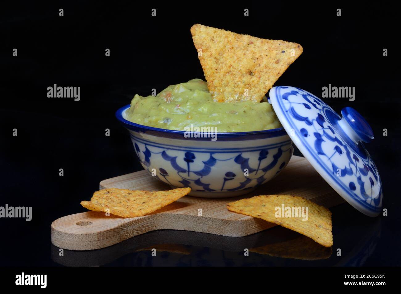 Bowl with guacamole and tortilla chips, Germany Stock Photo