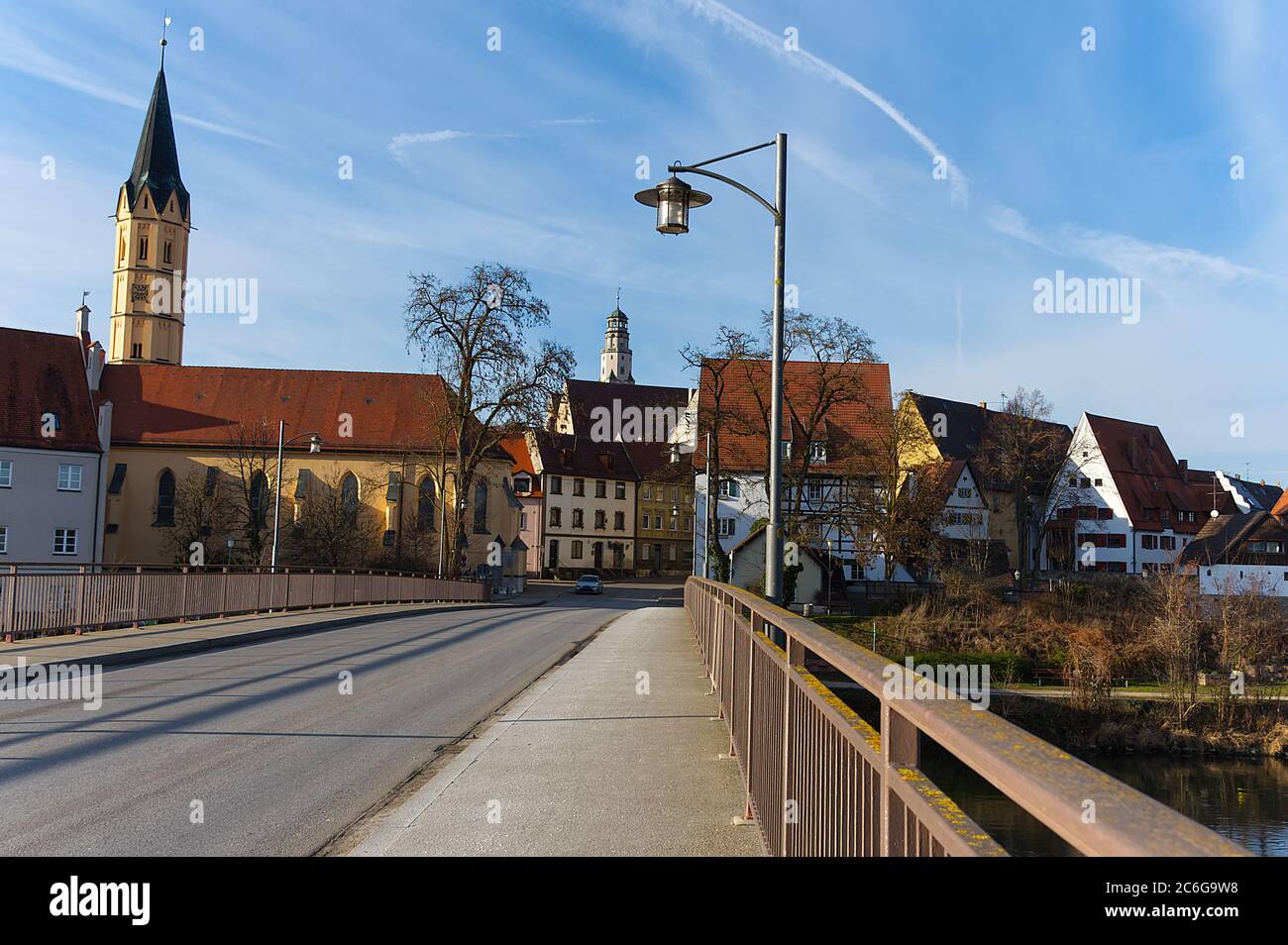 Walking over a Bridge and Looking at The City Lauingen with old Houses, Hospital Church St. Alban and White Horse Tower, Bavaria, Germany, Europe, Stock Photo