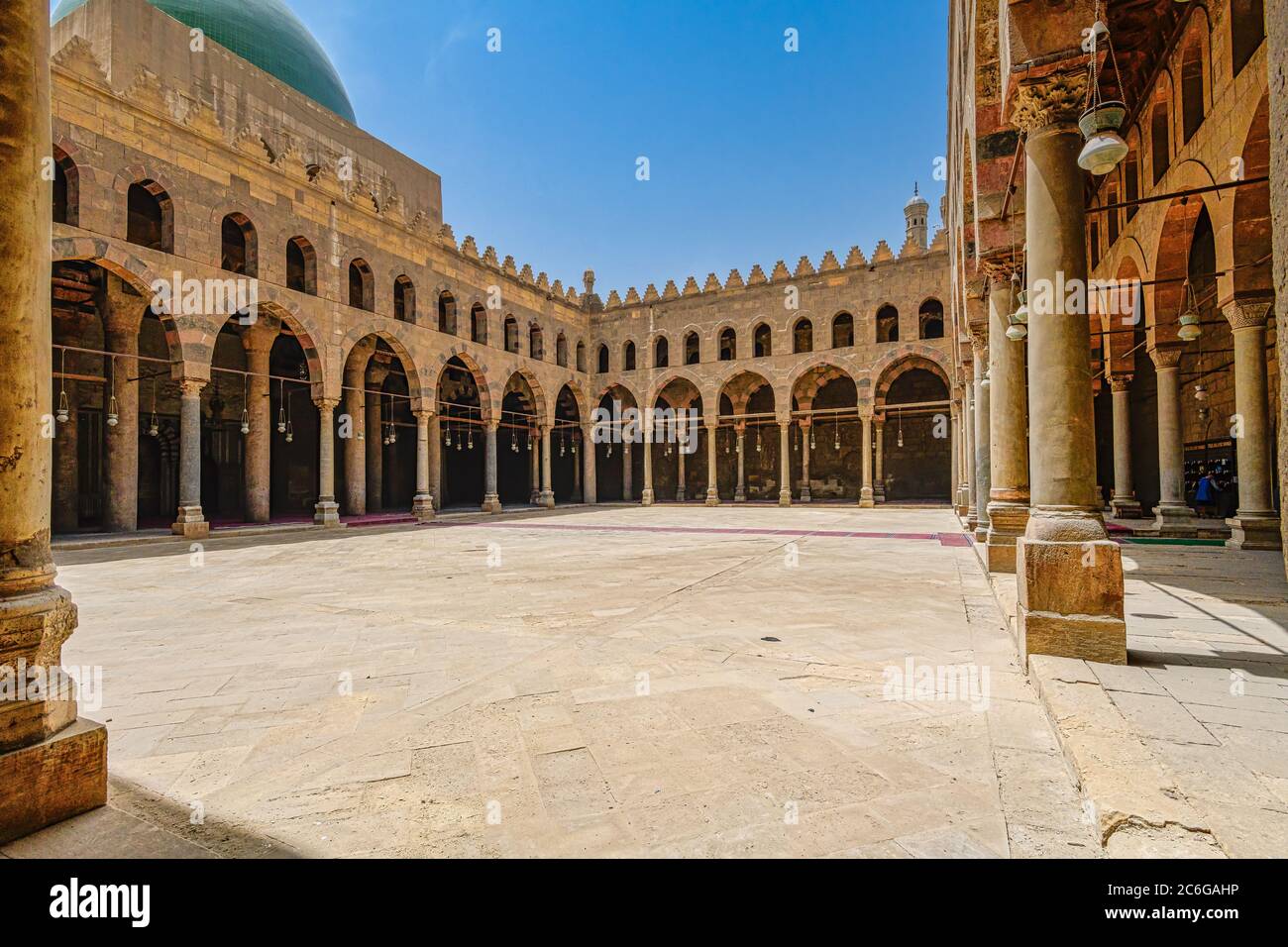Courtyard of the Al-Nasir Muhammad Mosque surrounded by rows of columns, forming the parallel arcaded sides Stock Photo