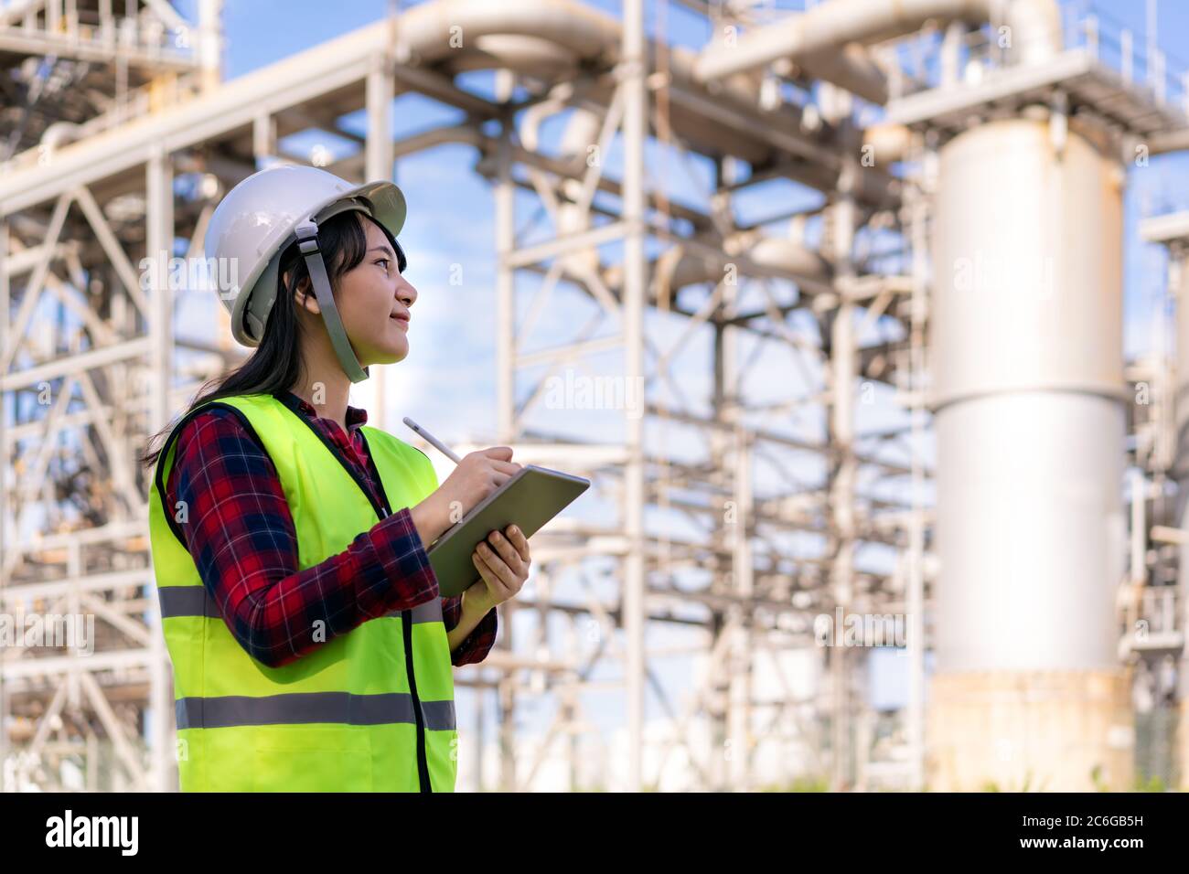 Asian woman petrochemical engineer working with digital tablet Inside