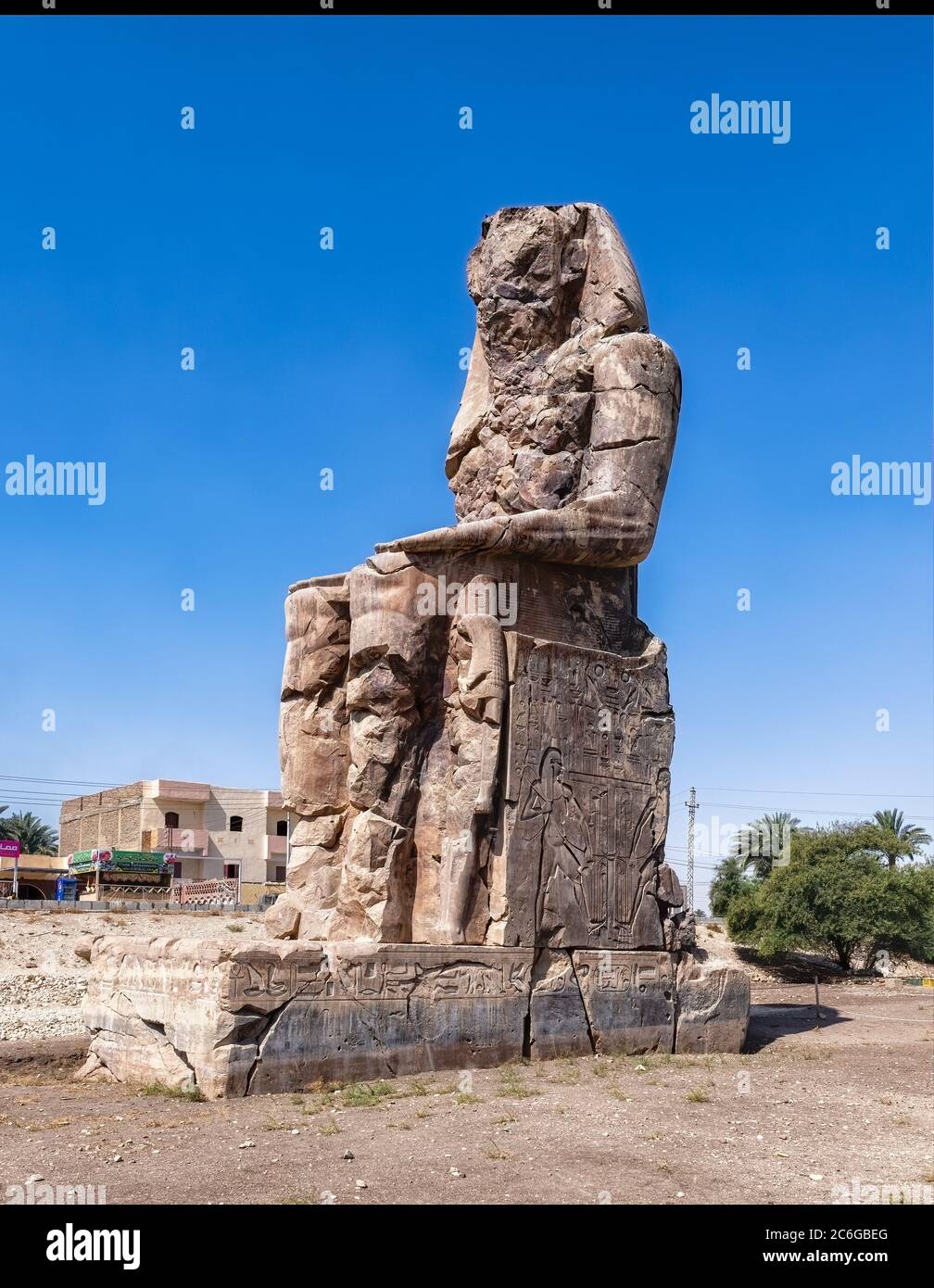 The Colossus of Memnon, one of two massive stone statues of the Pharaoh Amenhotep III located in the Mortuary Temple of Amenhotep III near Luxor Stock Photo