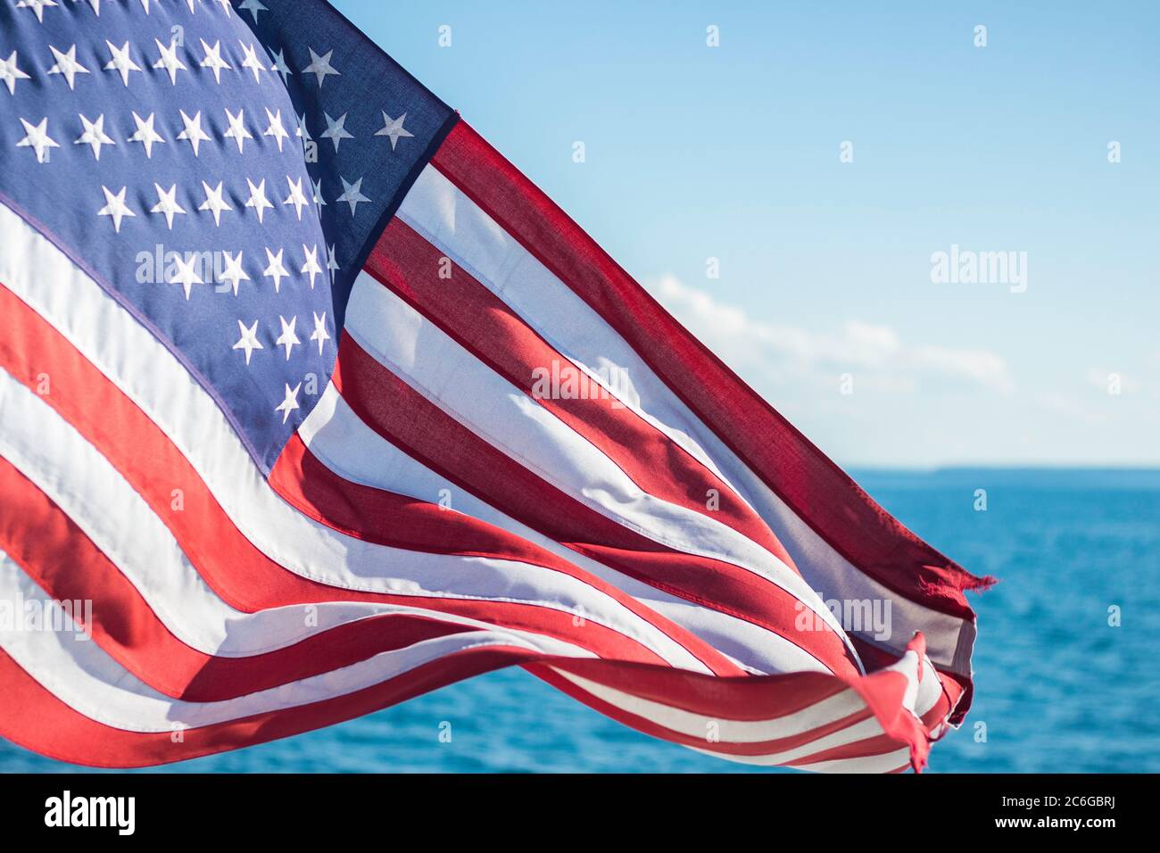 American Flag Waving in the Wind Above Lake Superior Stock Photo