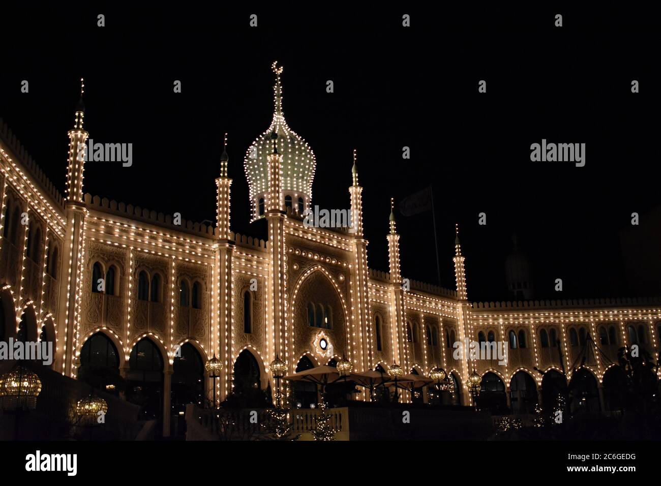 The Nimb hotel and restaurant in Tivoli Gardens lit up at night with white lights.  Moorish inspired design for the building in Copenhagen, Denmark. Stock Photo