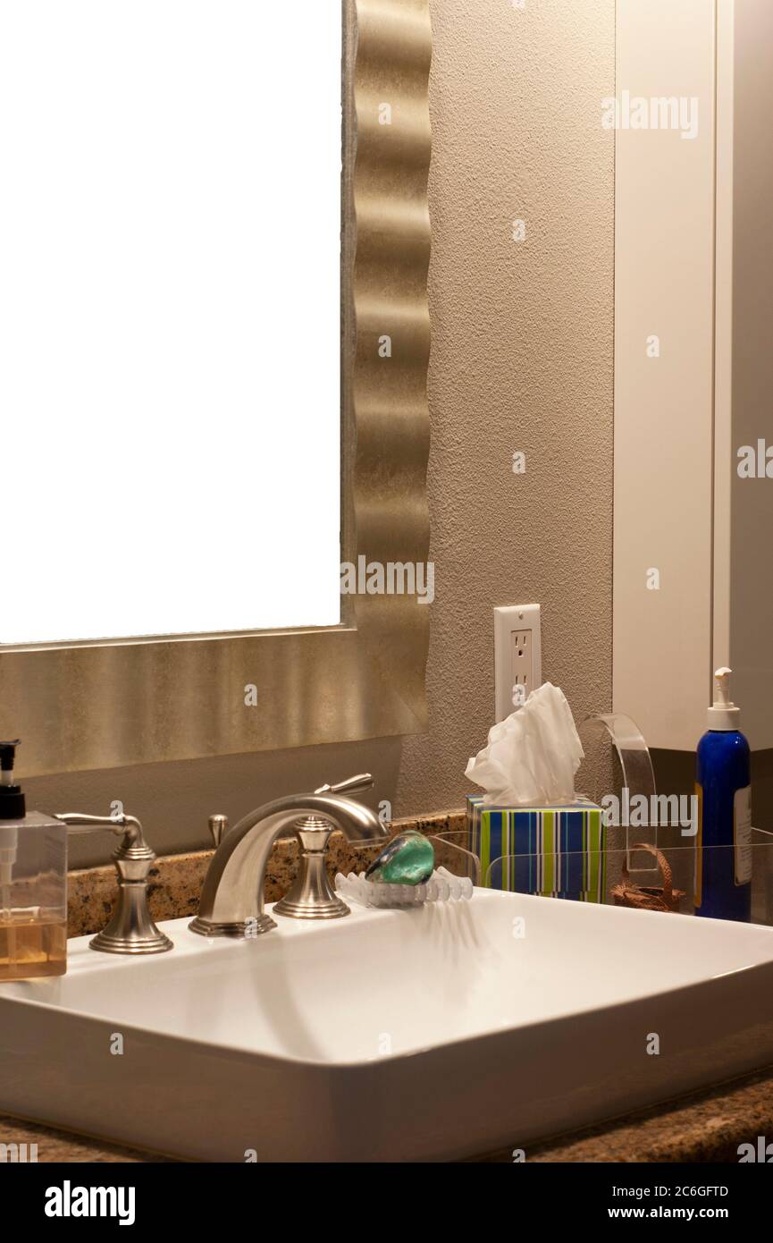 Bathroom sink and mirror closeup with text message space in mirror frame. Contemporary square sink builtin with granite surrounds. Stock Photo