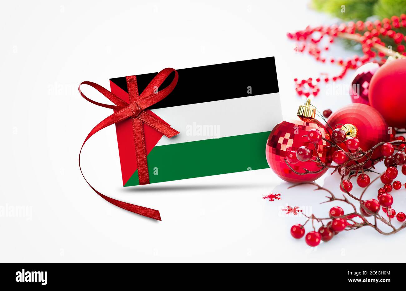 Palestine flag on new year invitation card with red christmas ornaments