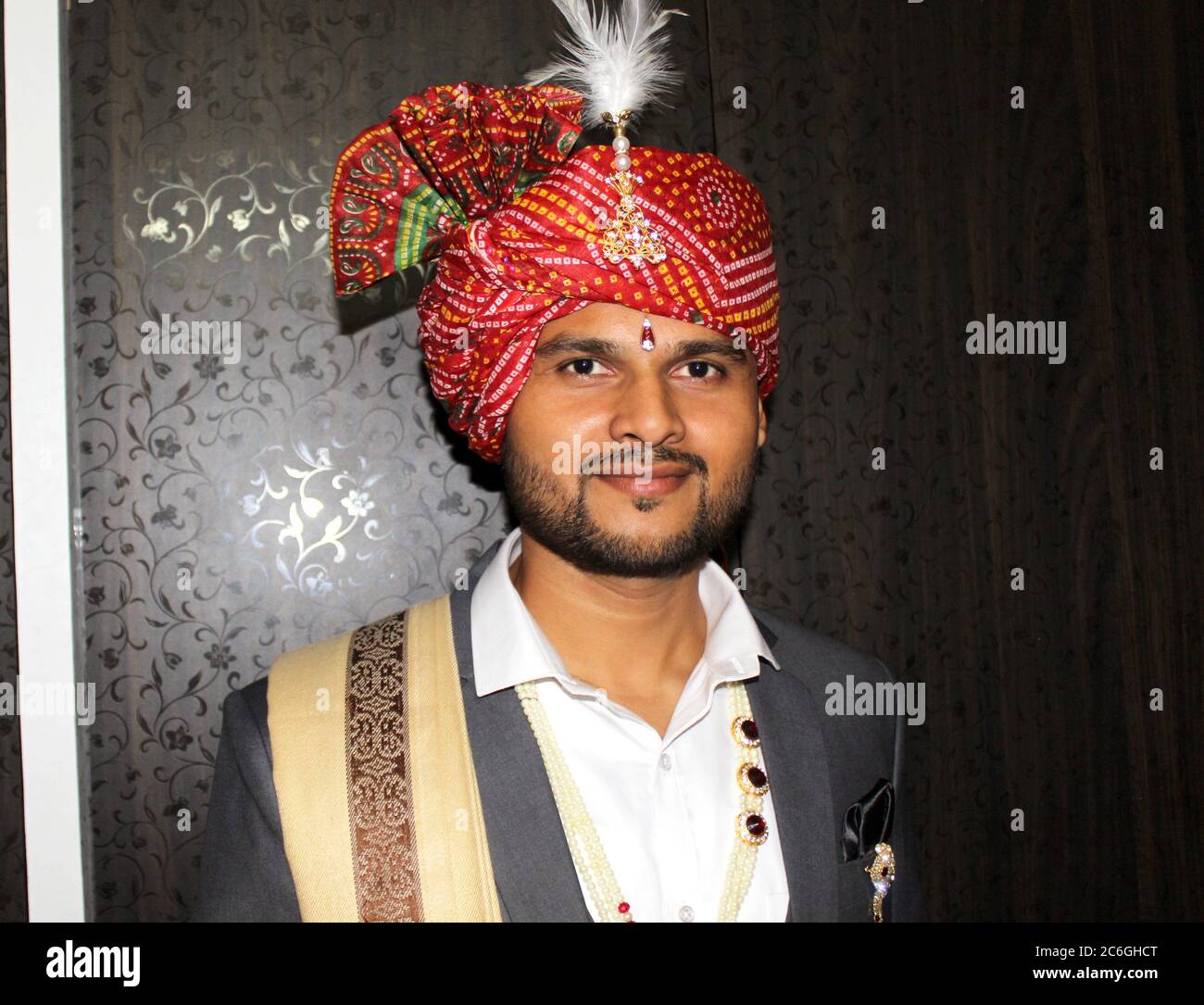 Indian groom in traditional dress with colorful turban portrait, selective focus with blur. Stock Photo