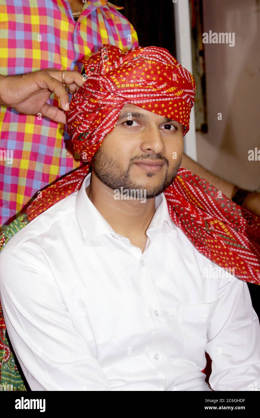 Asian man wearing turban with traditional style in indian hindu culture, Indian groom in colorful dress, selective focus with blur. Stock Photo