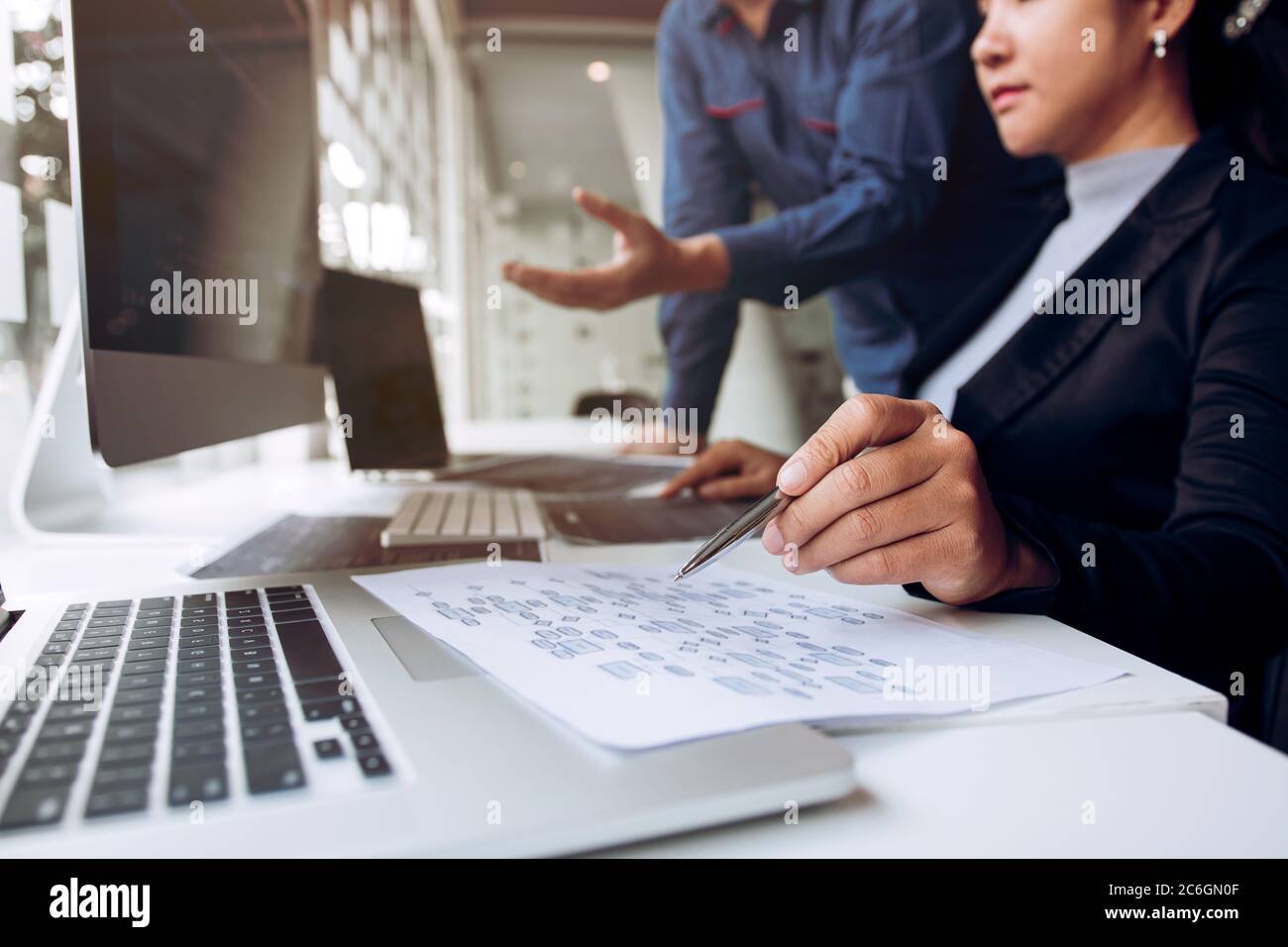 Two asian team working development of programming and encryption technology website design programmers on desk in office. Stock Photo