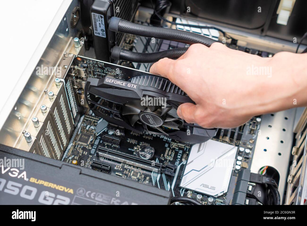 Installing graphic card in a computer Stock Photo
