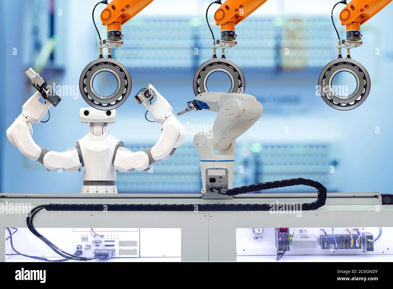 Industrial robotic and smart robot working with spherical roller bearing via gripping workpiece robot on smart factory Stock Photo