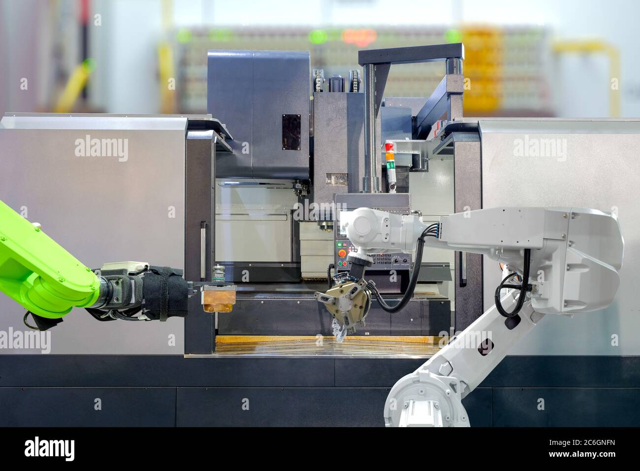 Industrial robotics teamwork on working with CNC lathe machine in smart factory on blurred background, industry 4.0 and technology concept Stock Photo