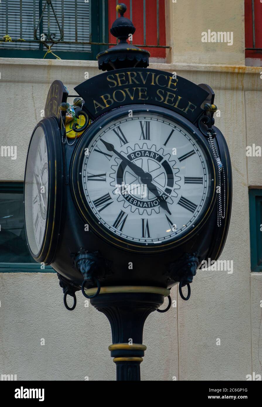 A four-sided post clock is draped in Mardi Gras beads on the corner of Royal Street and Dauphin Street, July 3, 2020, in Mobile, Alabama. Stock Photo