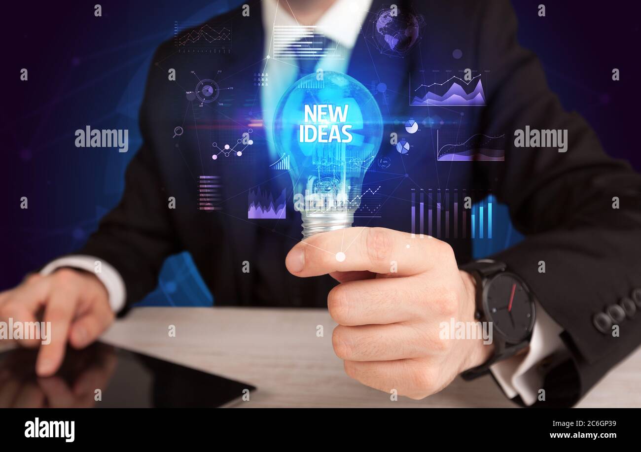 Businessman holding lightbulb with NEW IDEAS inscription, Business idea ...