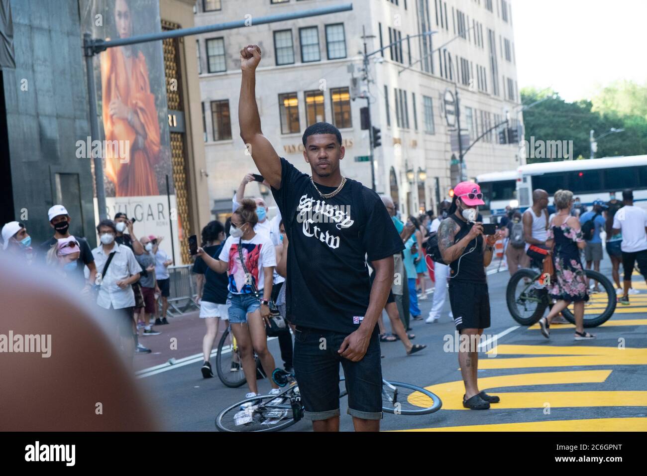 New York, United States. 08th July, 2020. A BLM protester holding up his fist for a picture in front of Trump Tower where a large Black Lives Matter mural was painted.As New York City enters phase 3 of reopening retail stores for indoor shopping, restaurants have been postponed for indoor dinning. Meanwhile Black Lives Matter protests continue in the city as the Mayor along with a group of people painted a large Black Lives Matter mural in front of Trump Tower on 5th Ave. Credit: SOPA Images Limited/Alamy Live News Stock Photo
