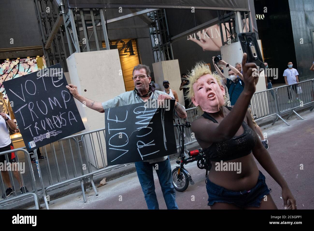 New York, United States. 08th July, 2020. A BLM protester takes a selfie in front of a Trump supporter outside the Trump Tower where a large Black Lives Matter mural was painted.As New York City enters phase 3 of reopening retail stores for indoor shopping, restaurants have been postponed for indoor dinning. Meanwhile Black Lives Matter protests continue in the city as the Mayor along with a group of people painted a large Black Lives Matter mural in front of Trump Tower on 5th Ave. Credit: SOPA Images Limited/Alamy Live News Stock Photo